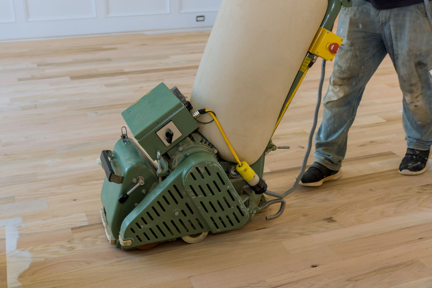 A Footprints Floors expert performing a floor refinishing.