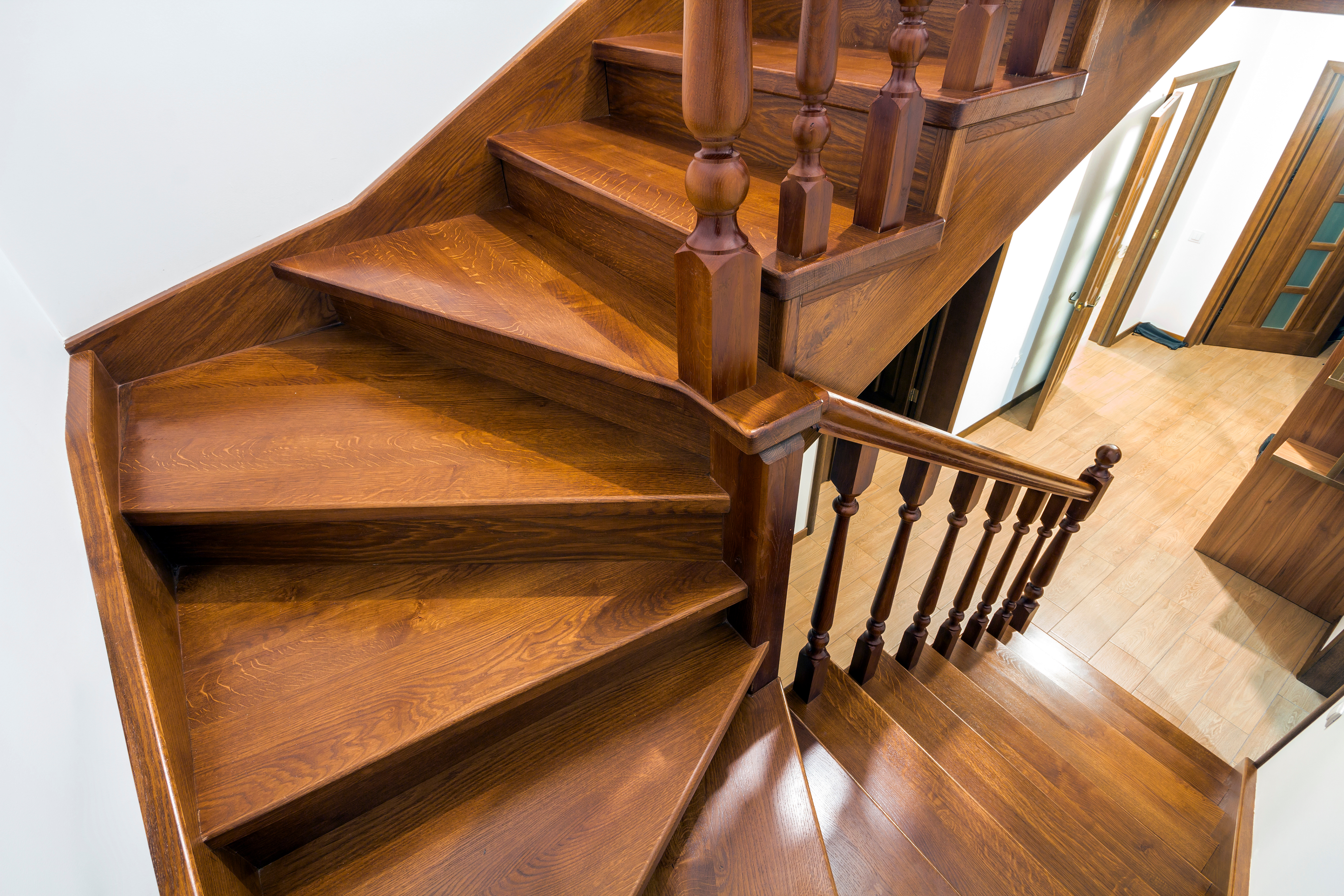 A picture of wooden stairs installed by the experts at Footprints Floors.