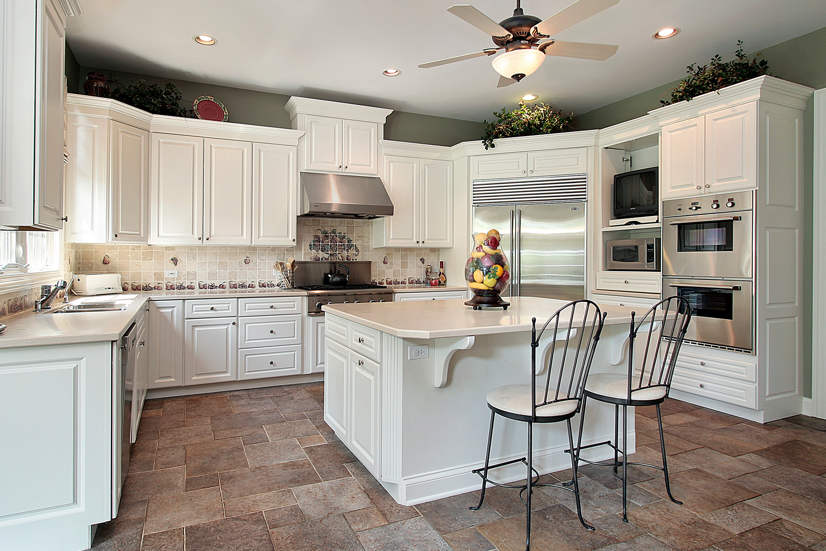 A kitchen with newly installed slate stone flooring.